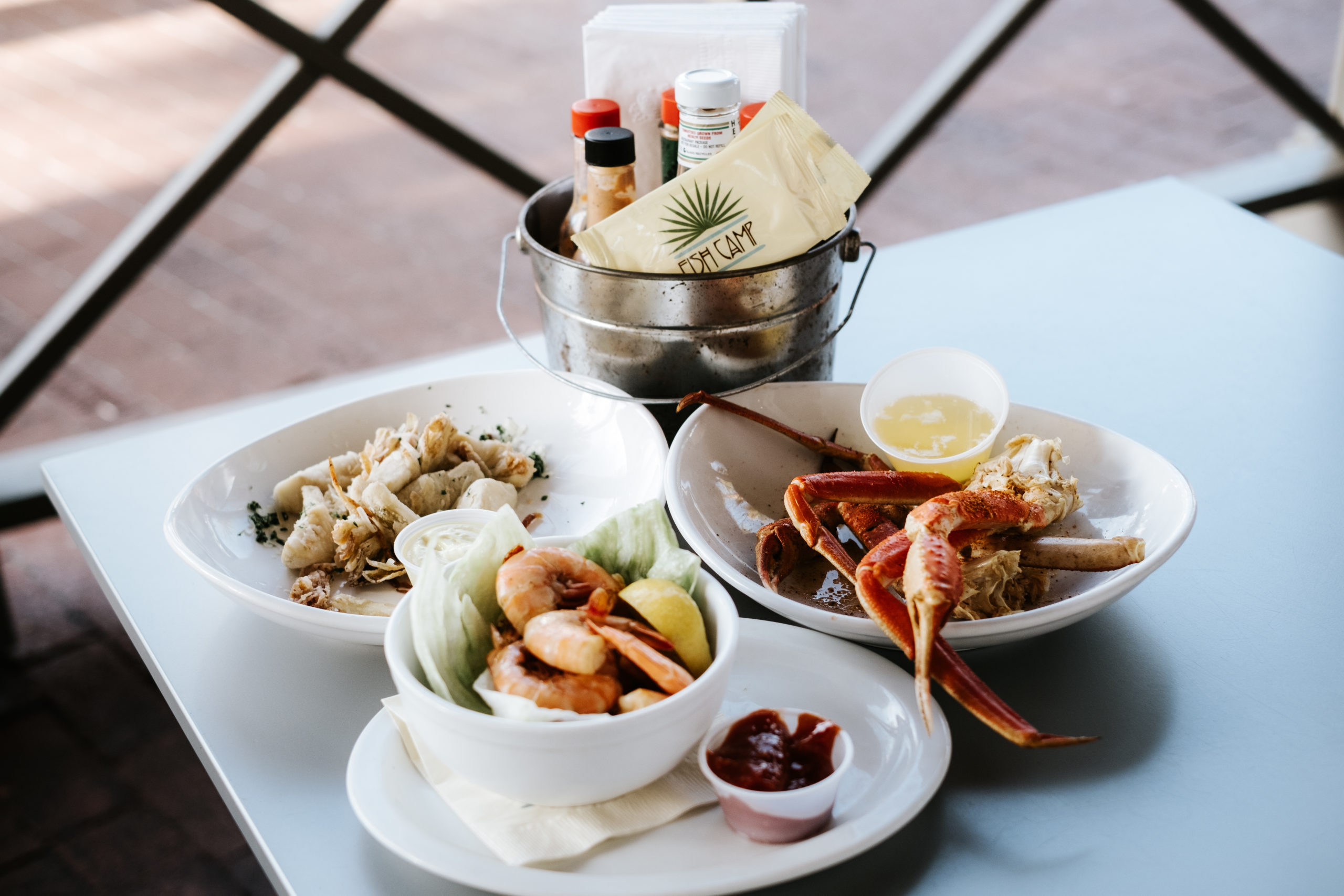 A platter of freshly-prepared seafood delicacies, salads, and side dishes is artfully arranged on the table, creating a delicious brunch spread.