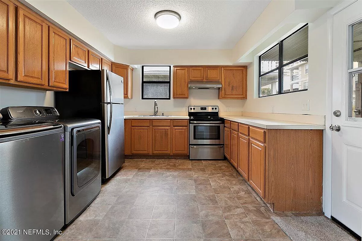 A spacious kitchen with washer and dryer, stove and refrigerator included